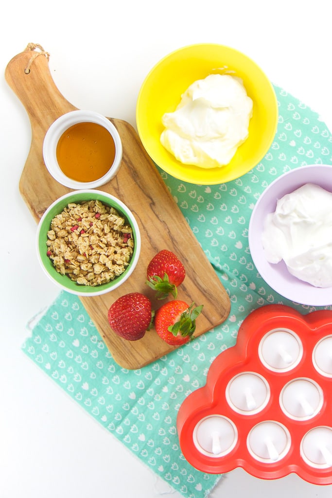Everything you need to make healthy yogurt parfait popsicles for toddler + kids - yogurt, strawberries, granola honey.