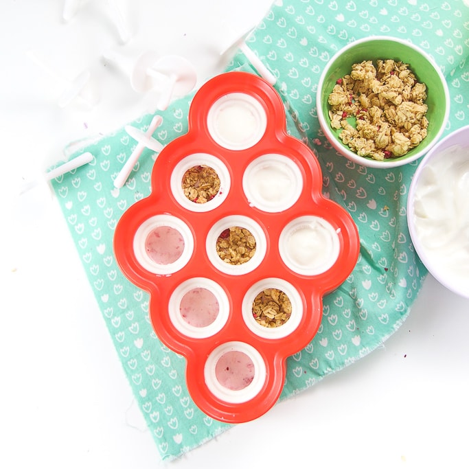 Mini mold is filled with different layers of popsicles for toddler and kids