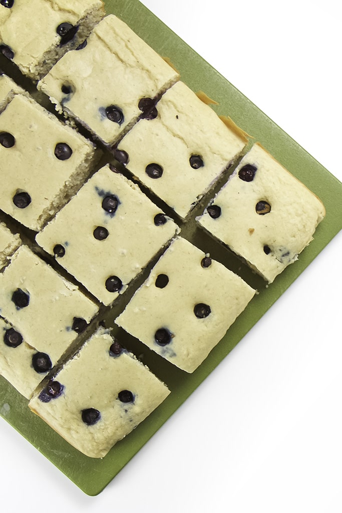 Picture of blueberry sheet pan pancakes sitting on a cutting board.