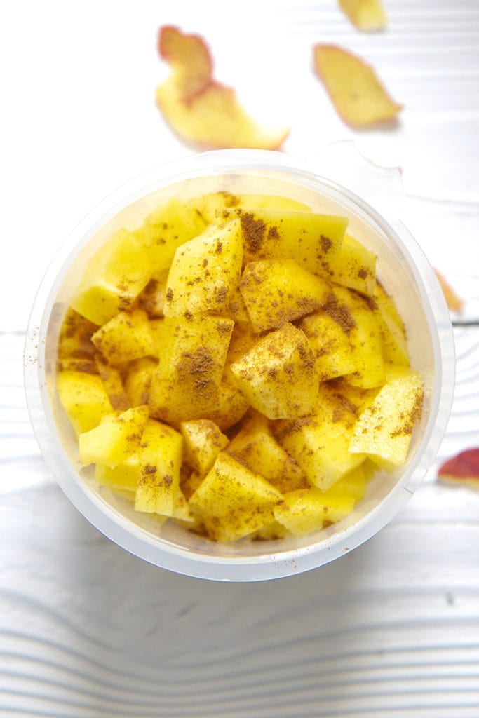 Bowl of peaches getting ready to be steamed with a sprinkle of cinnamon on top.