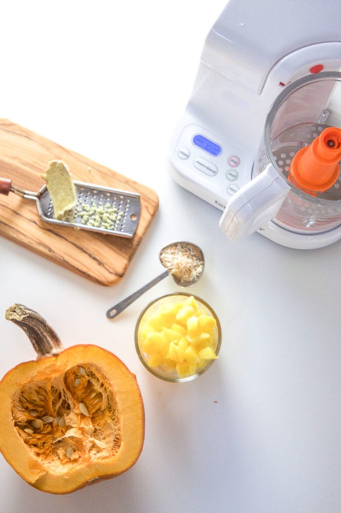 A spread of pumpkin and produce with a baby food making machine.