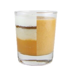 Clear cup half filled with ingredients for the puree and the other half of the cup is the homemade baby food puree.