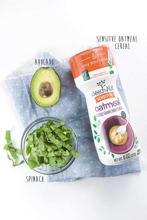 Produce and oat baby cereal scattered on white background.