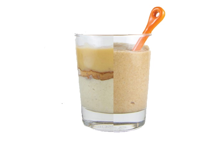 Clear cup - on one side is ingredients in the baby puree, on the other is the puree itself with an orange spoon inside.