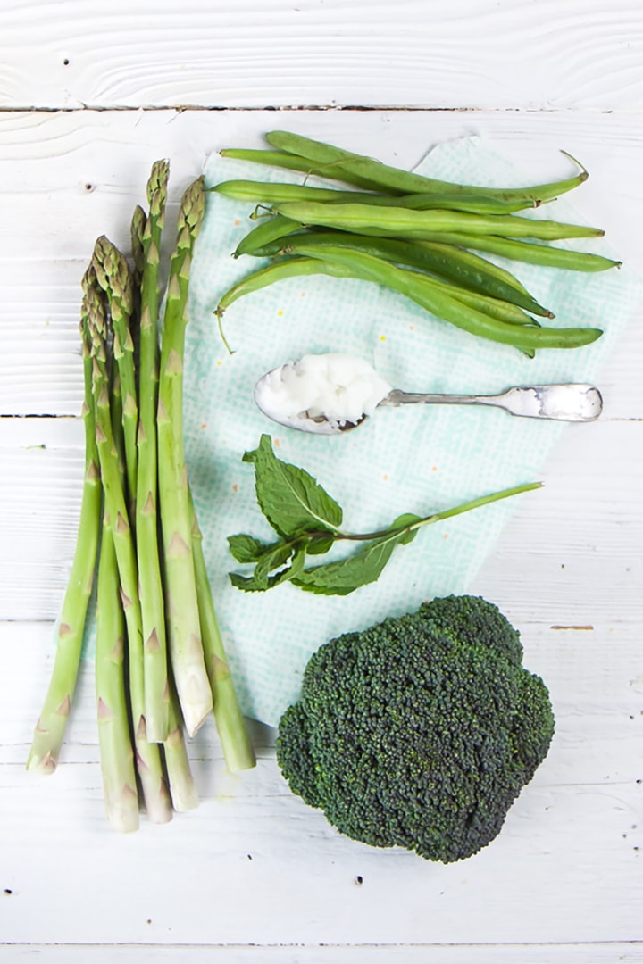 Green produce sitting on a white board.
