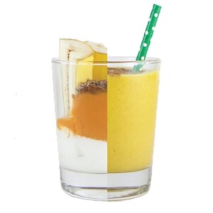 Clear cup cut in half, on one side is the ingredients for the smoothie, on the other side is the smoothie itself with a straw sticking out.