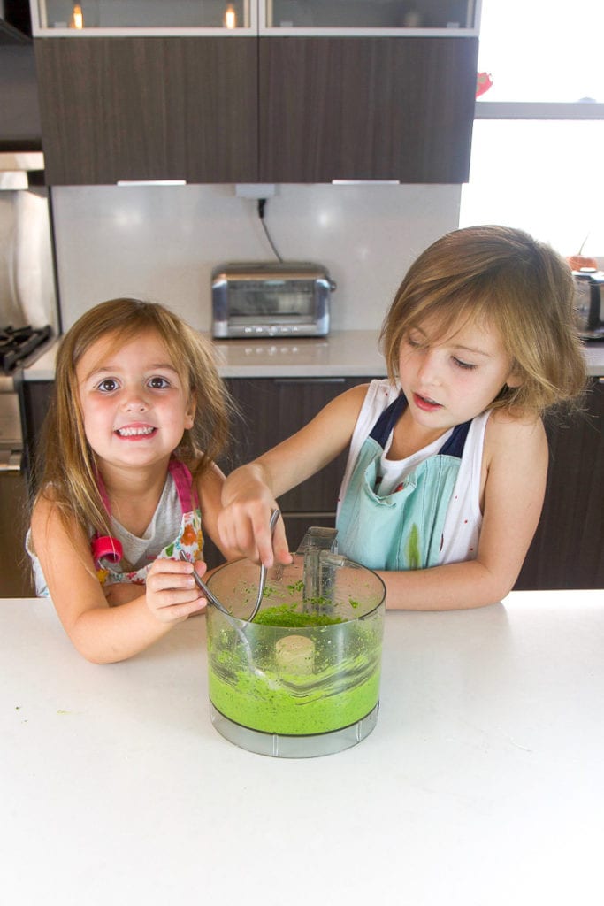 2 girls taste testing a recipe they made by themselves.