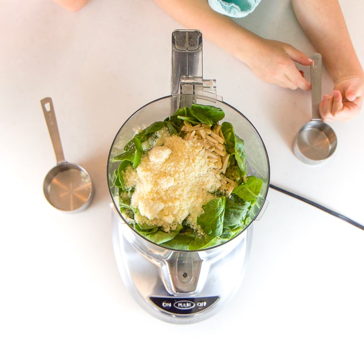 Overhead shot of food processor with ingredients inside of it.
