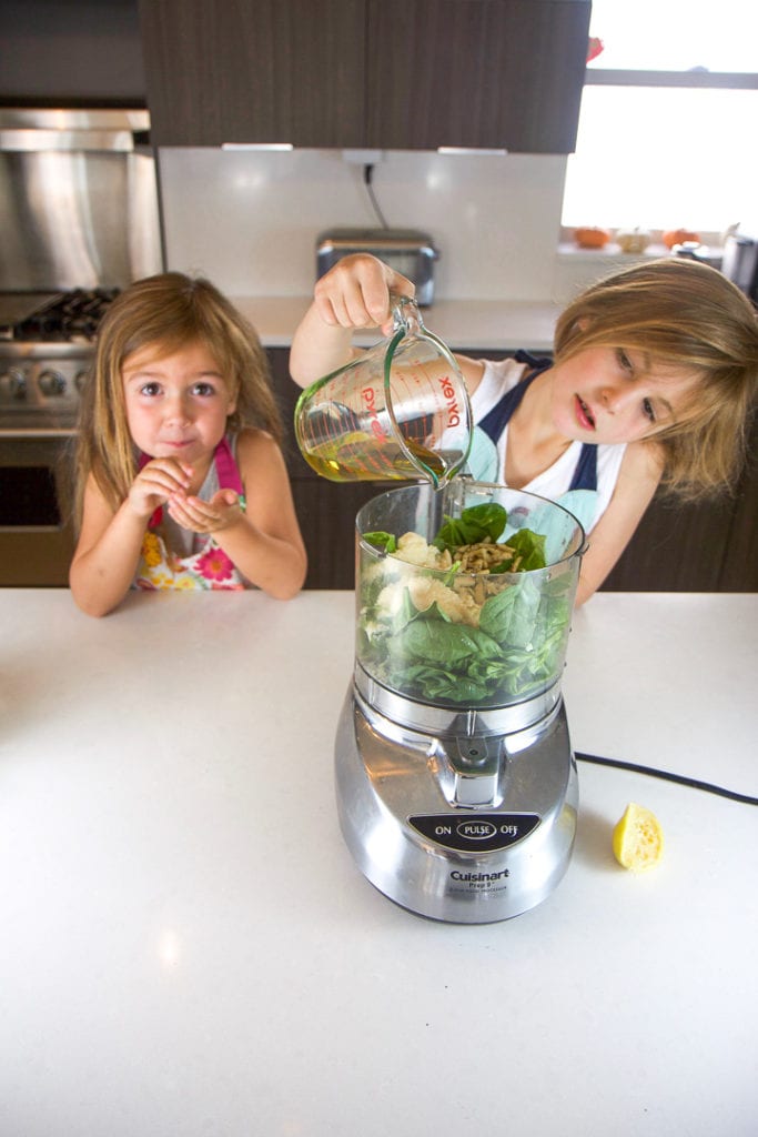 2 girls making a recipe by cooking in the kitchen.