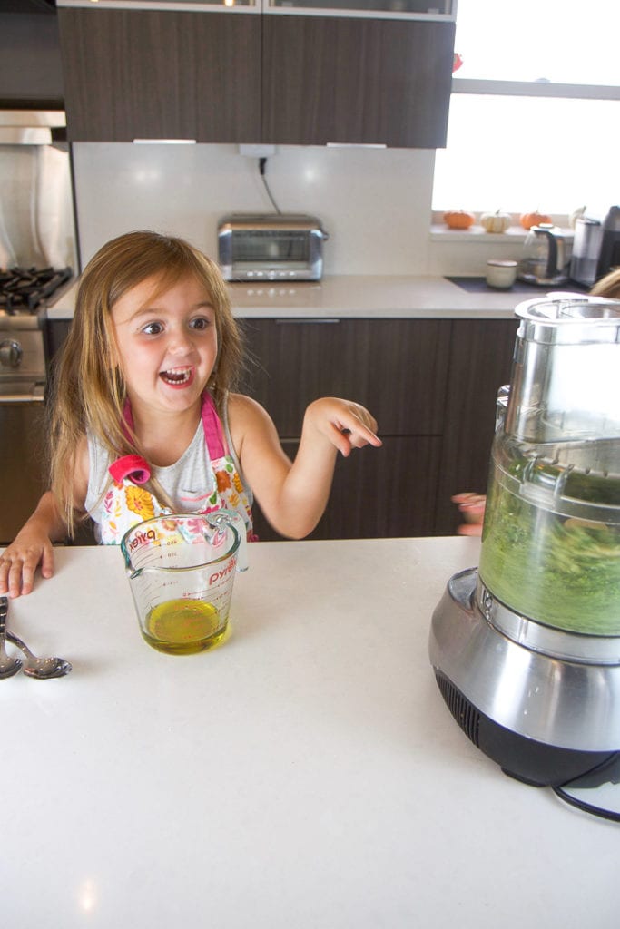 kids cooking in the kitchen - making a pesto recipe.