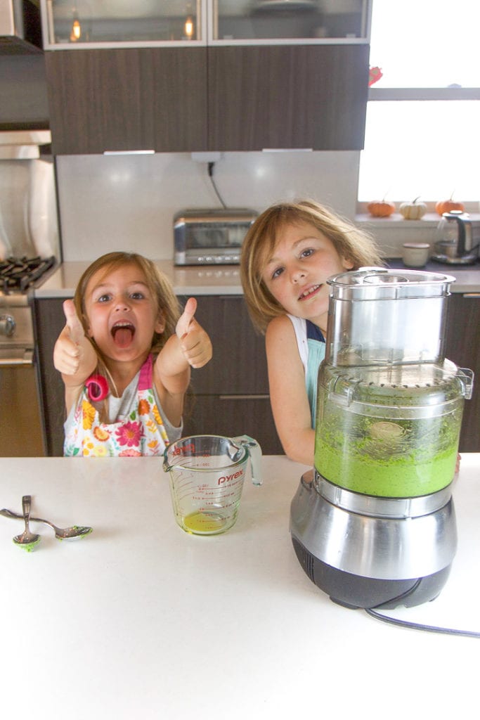 2 kids very excited about cooking in the kitchen.