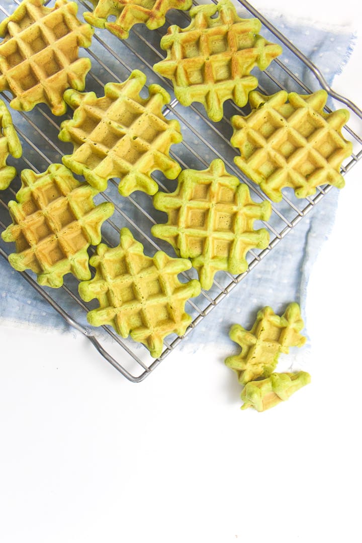 Spinach waffles sitting on a cooling rack.