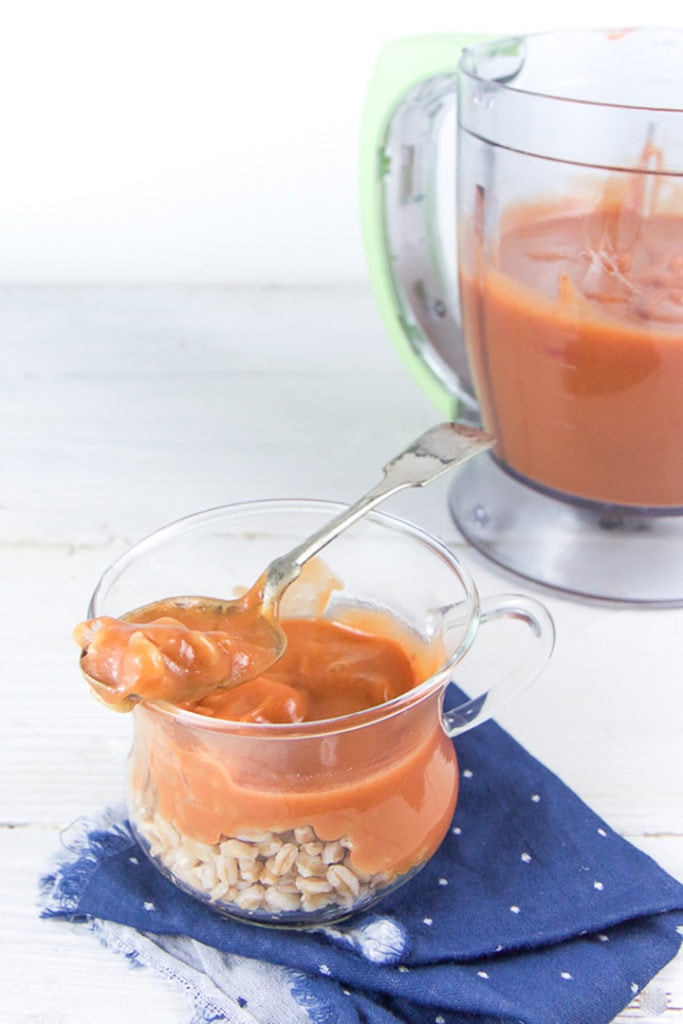 Clear jar will chunky strawberry Farro baby puree.