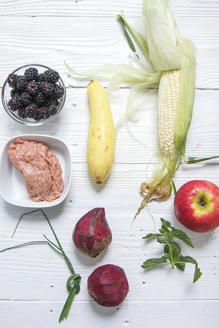 Spread of produce on a white wood board.