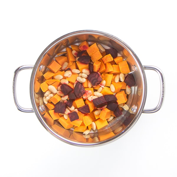 steamer basket filled with cooked produce.