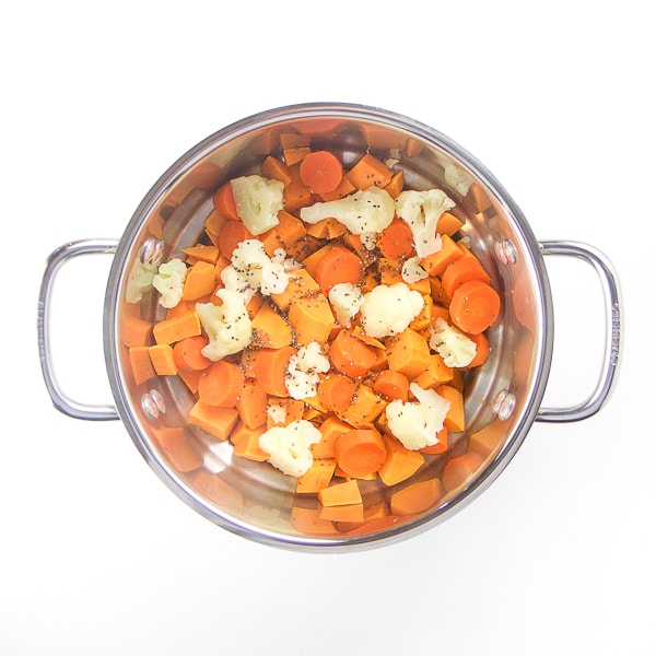 steamer basket filled with cooked produce.