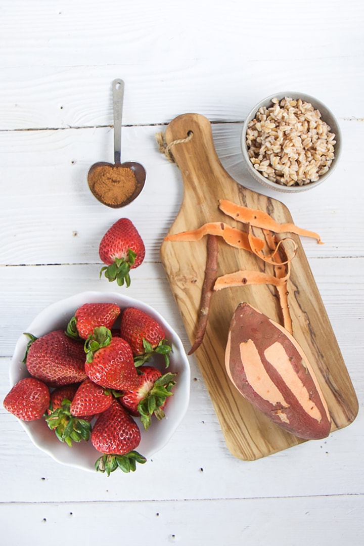Spread of produce on a cutting board and white wooden board.