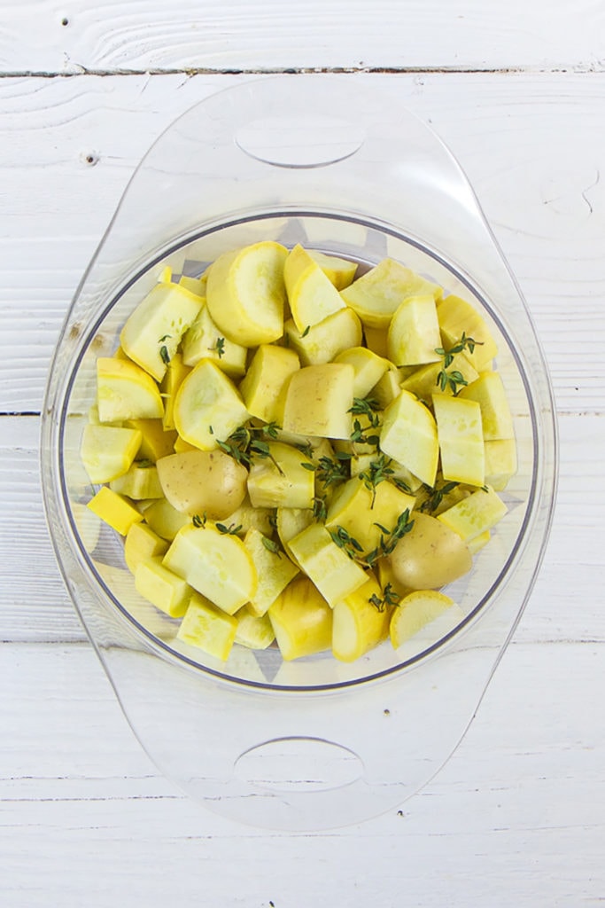 Cooked produce in a steamer basket.