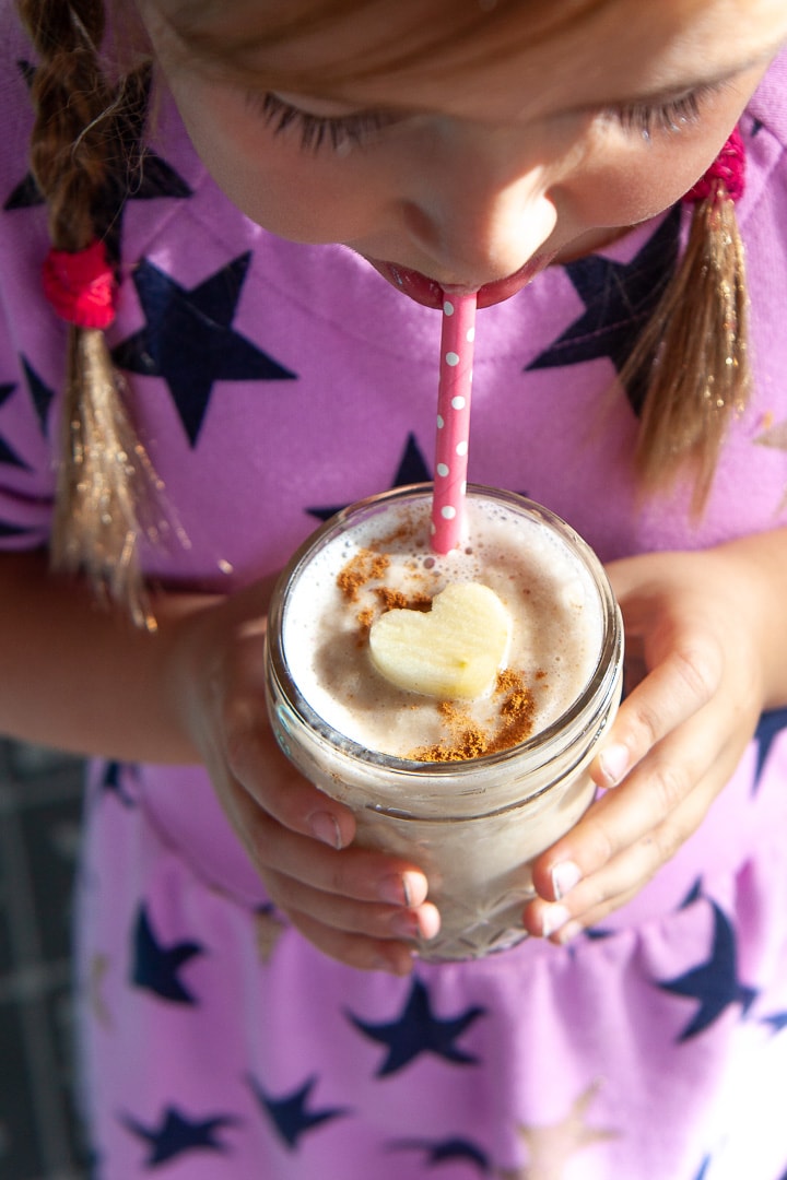 Girl holding an apple pie smoothie.