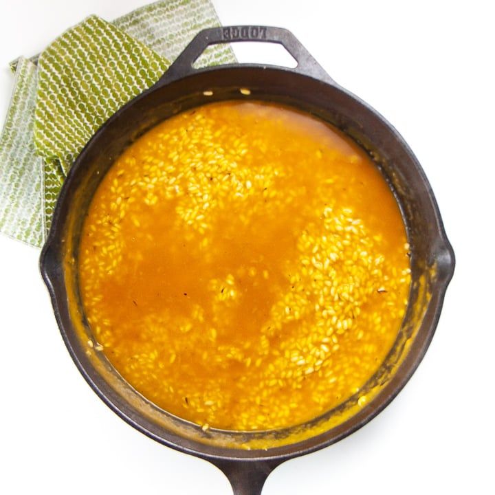 Risotto in a cast iron skillet - cooking with stock.