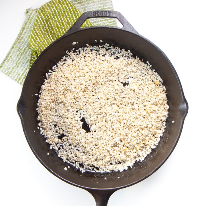 Risotto in a cast iron skillet - rice is browned.
