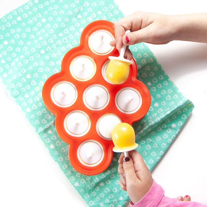 2 young hands reaching for a vitamin c cold buster popsicles