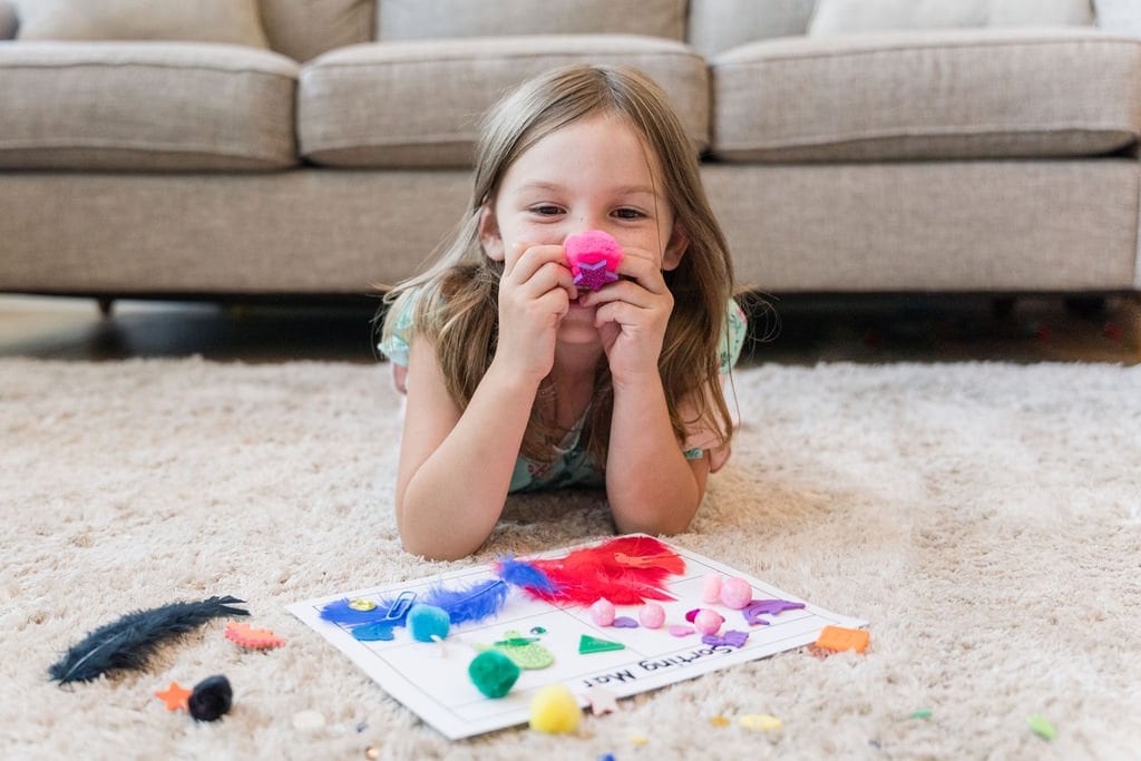 Young girl laying on the floor with a subscription box.
