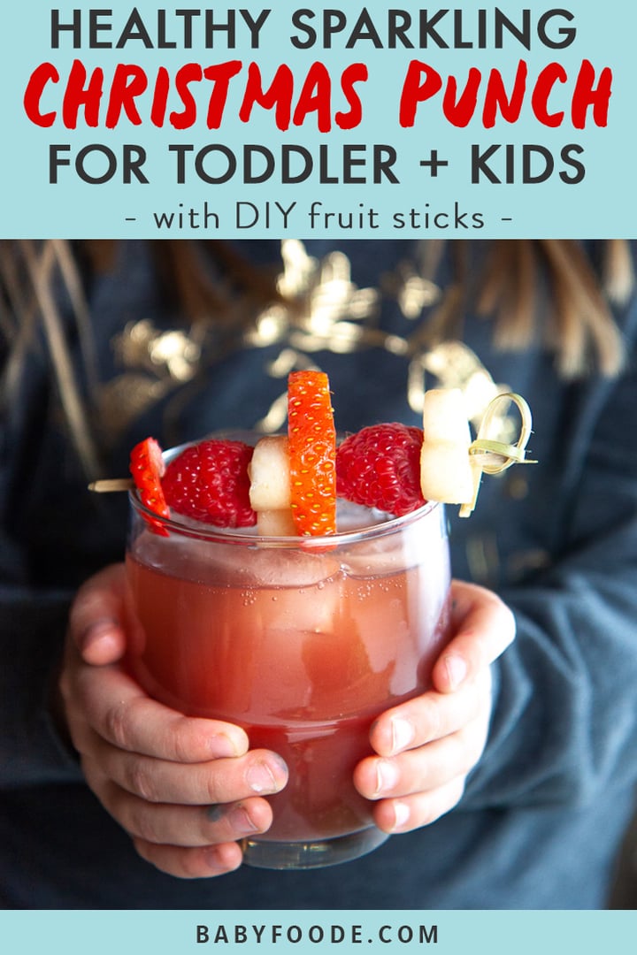 Graphic for Post - Healthy Sparkling Christmas Punch for Toddler + Kids.- with DIY fruit sticks with image of Small girl holding a glass of healthy Christmas punch