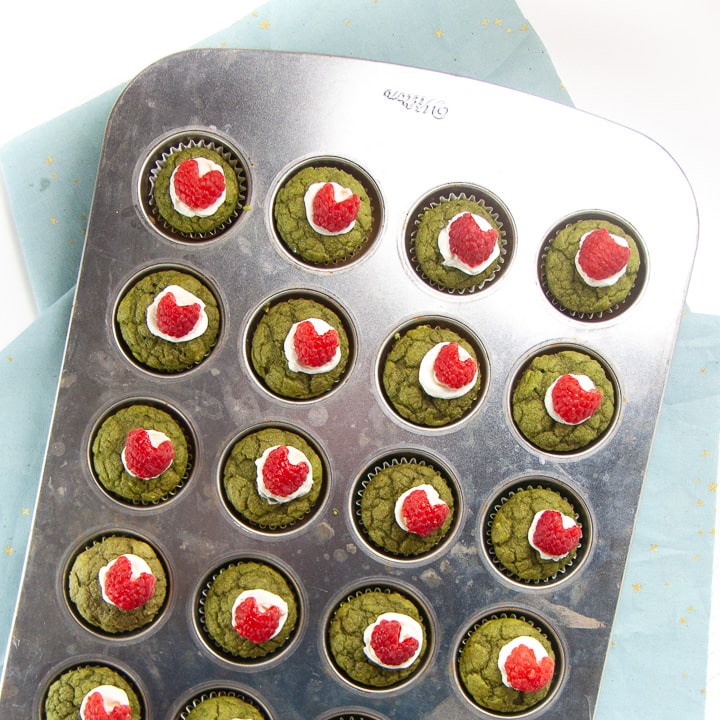 Full pan of cooked and decorated Grinch Mini Muffins for Baby and Toddlers.