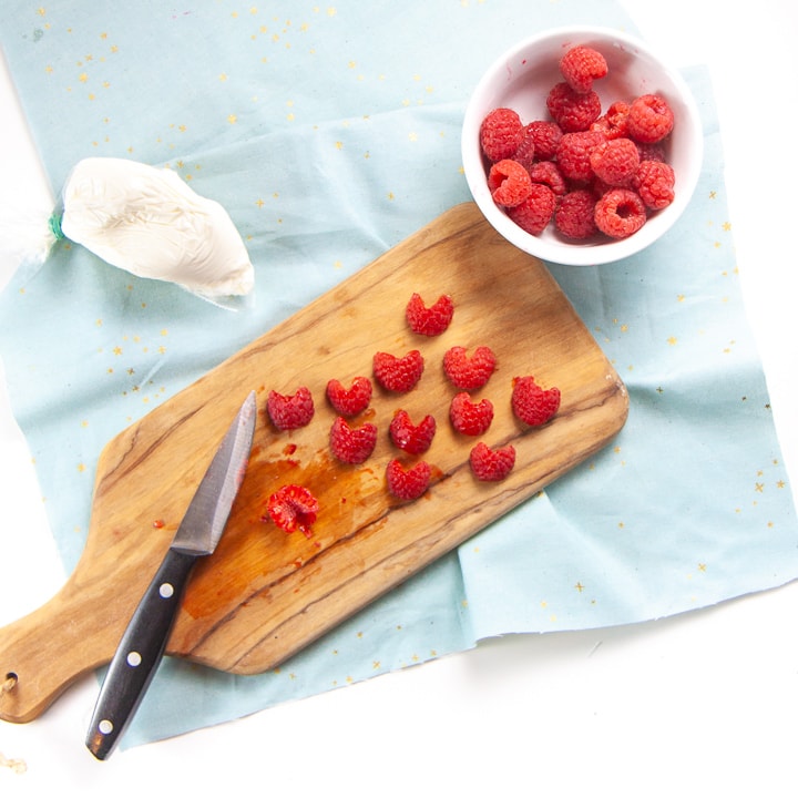 Raspberries cut into heart shapes.