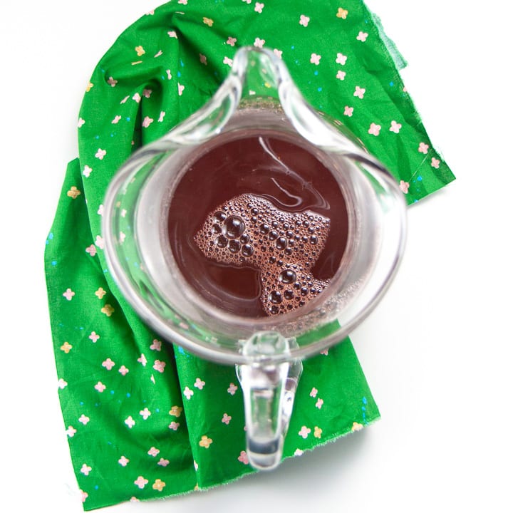 Clear pitcher with ingredients for kid and toddler punch.