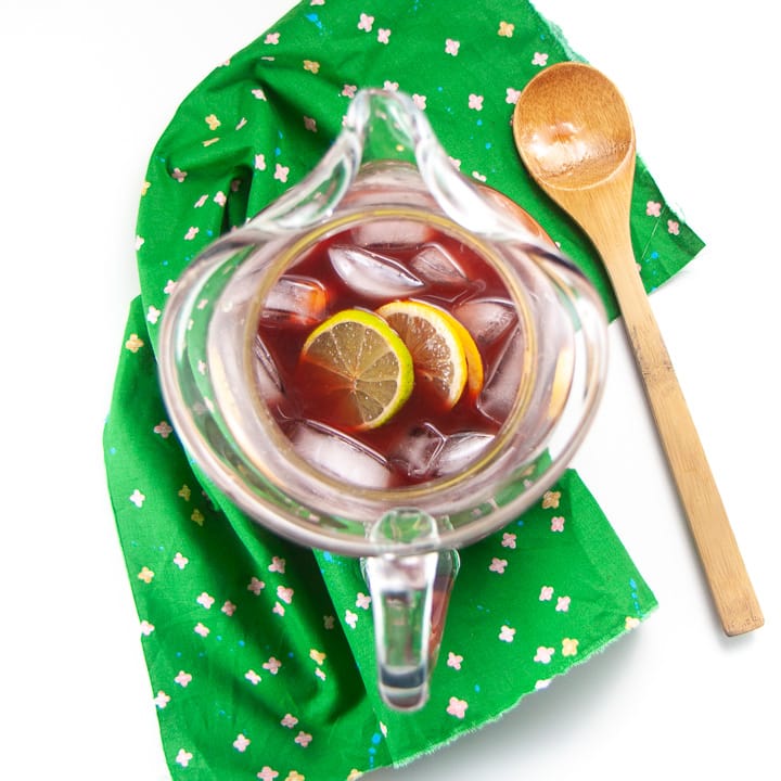 Clear pitcher with juice, ice and fruit for chirstmas punch