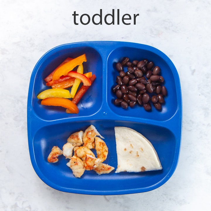 toddler plated loaded with shrimp tacos.