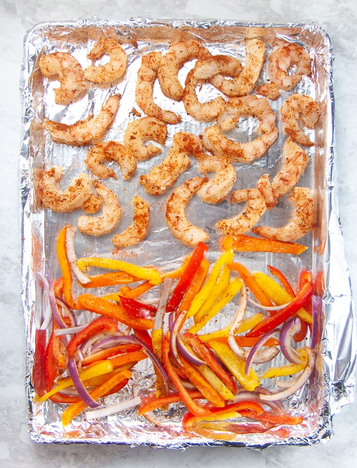 sheet pan with peppers and shrimp ready to cook.