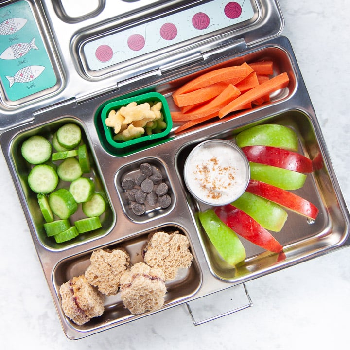 school lunch box filled with apples and spiced dip.
