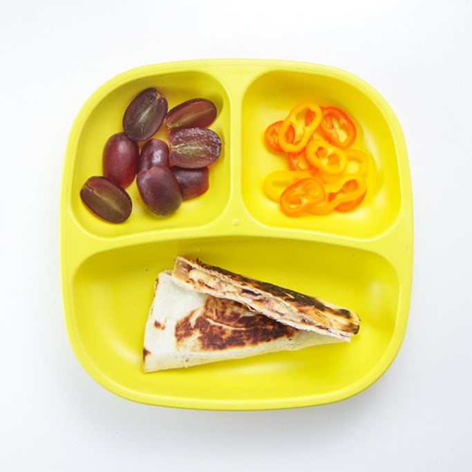 quesadilla with fruit and veggie for toddler lunch.
