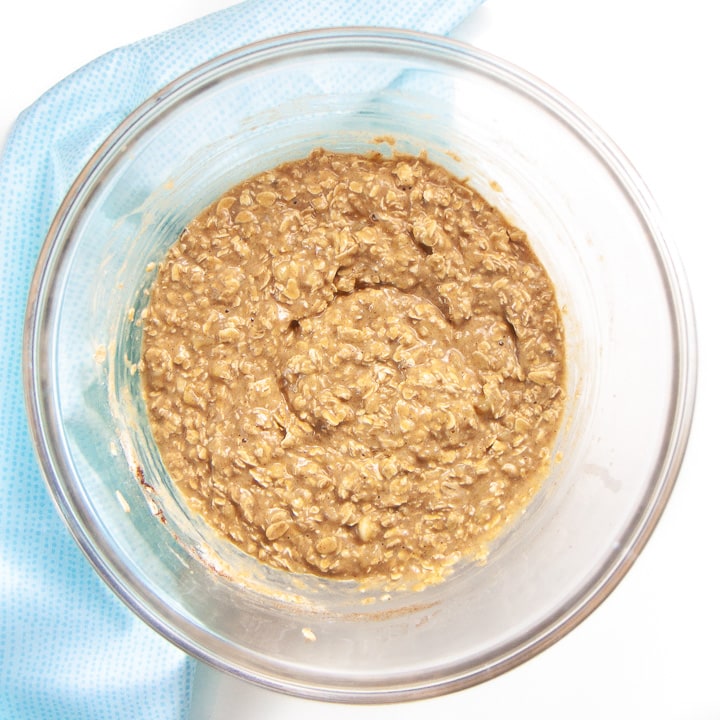 Bowl full of mixed ingredients for banana peanut butter oat bake.