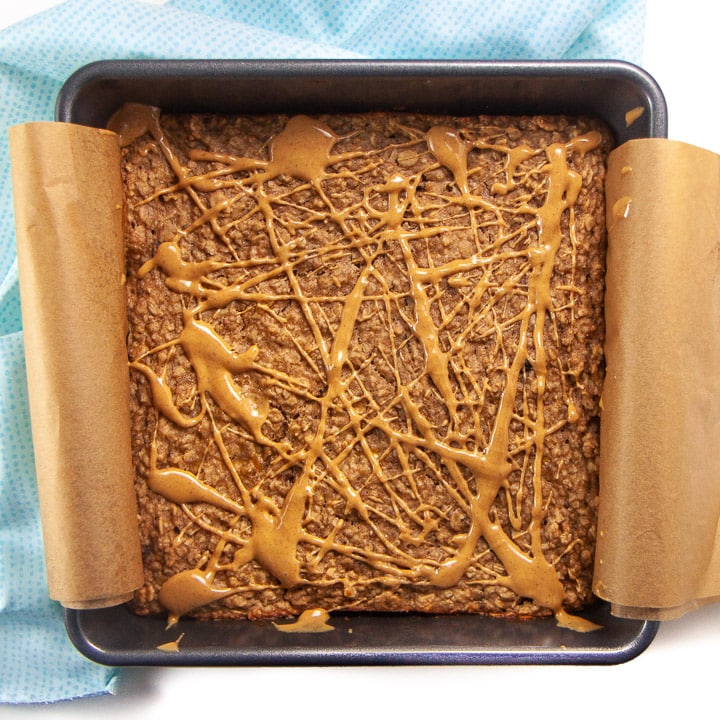 Banana peanut butter oatmeal bake with swirl of peanut butter on top.