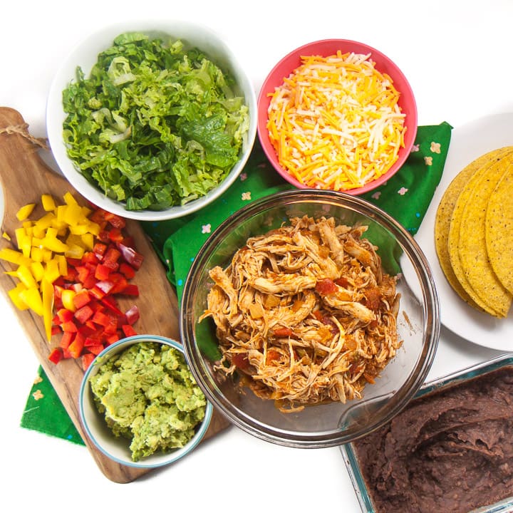 Spread of taco night for family with easy salsa chicken as the main.
