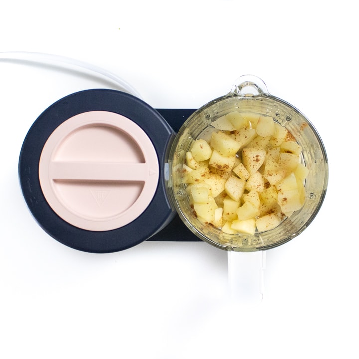 BEABA babycook with chunks of cooked apple inside the glass container.