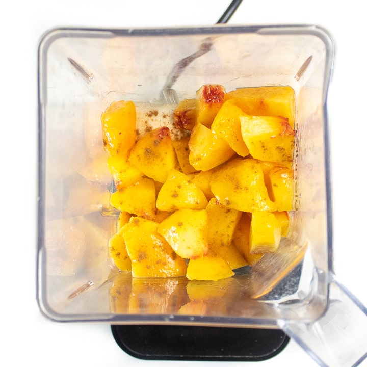blender with peaches and bananas ready to blend up.