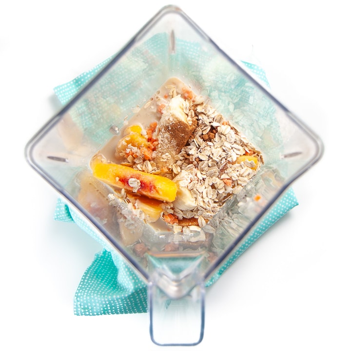 blender full of peach pie smoothie ingredients