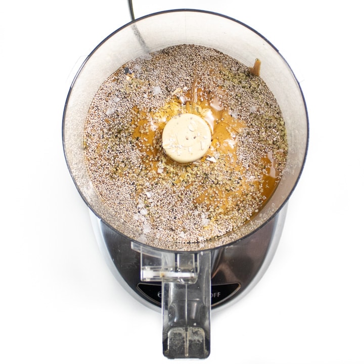 food processor with ingredients for energy balls inside.