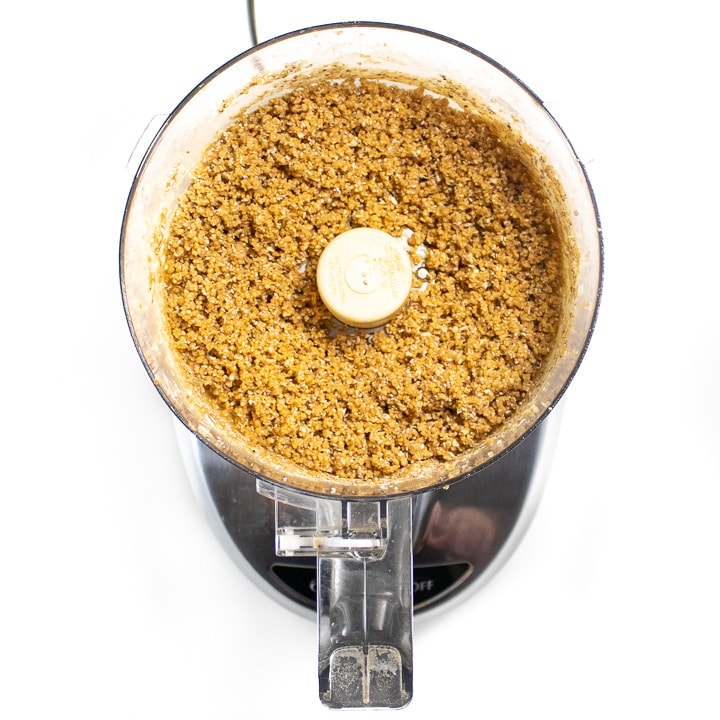 food processor with mixed energy balls inside.