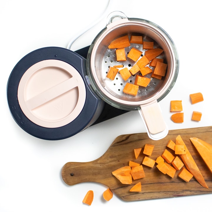 Spread showing Beaba babycook with a cutting board next to it with chopped sweet potato.