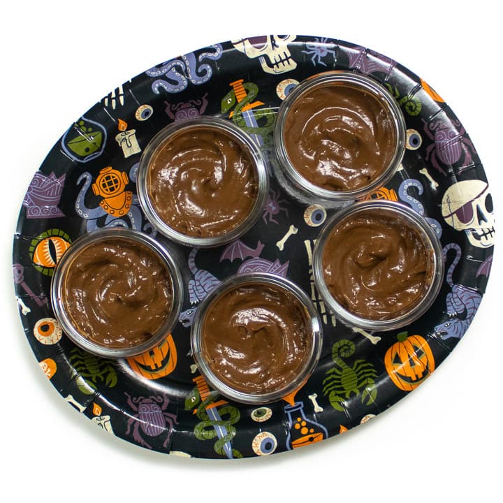 Plate of avocado pudding in cups.
