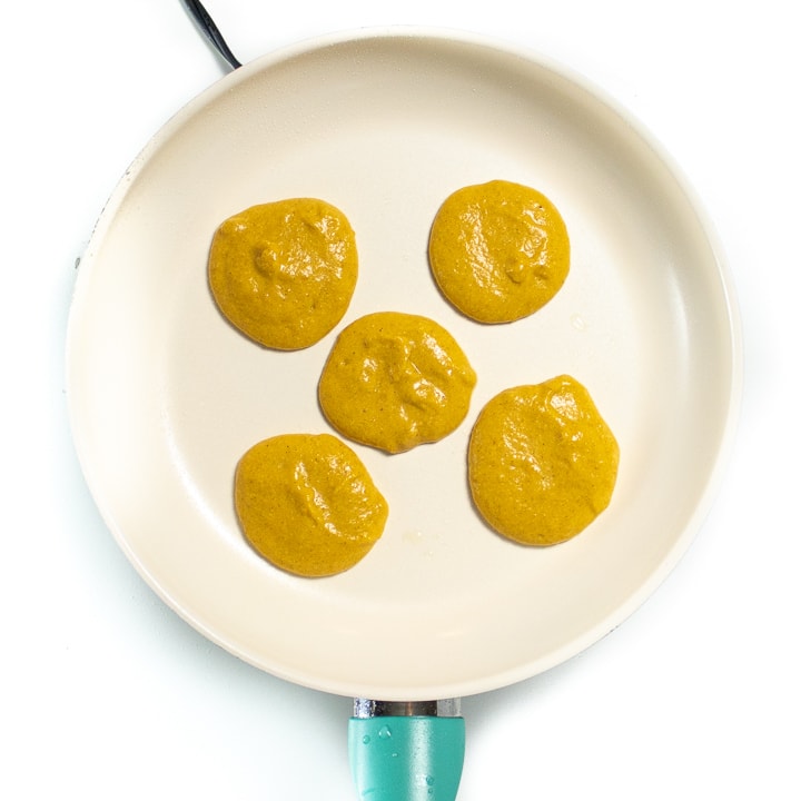 Cooking pumpkin pancakes on a skillet.