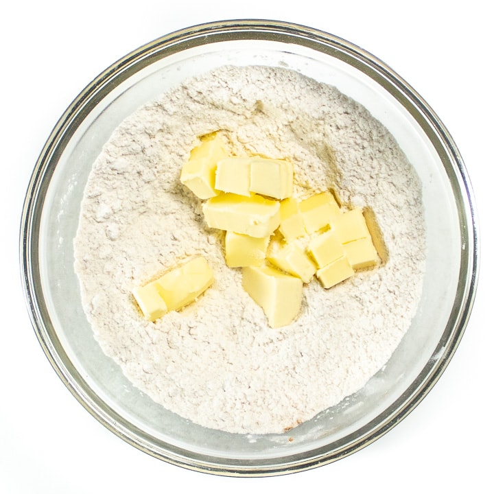Bowl full of flour and butter for pumpkin biscuits.