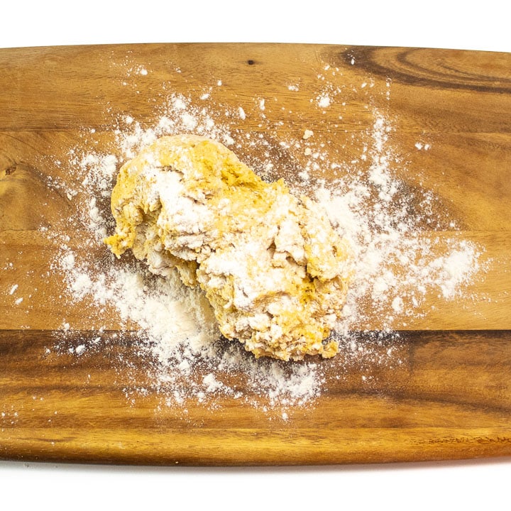 Dough on cutting board ready to be rolled out.