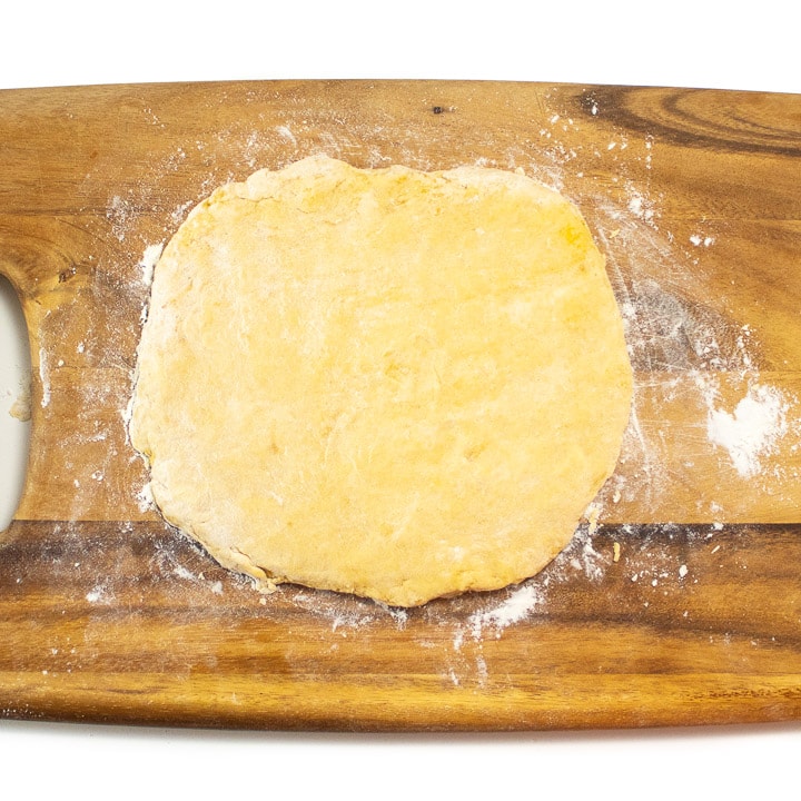 Dough for pumpkin biscuits rolled out.
